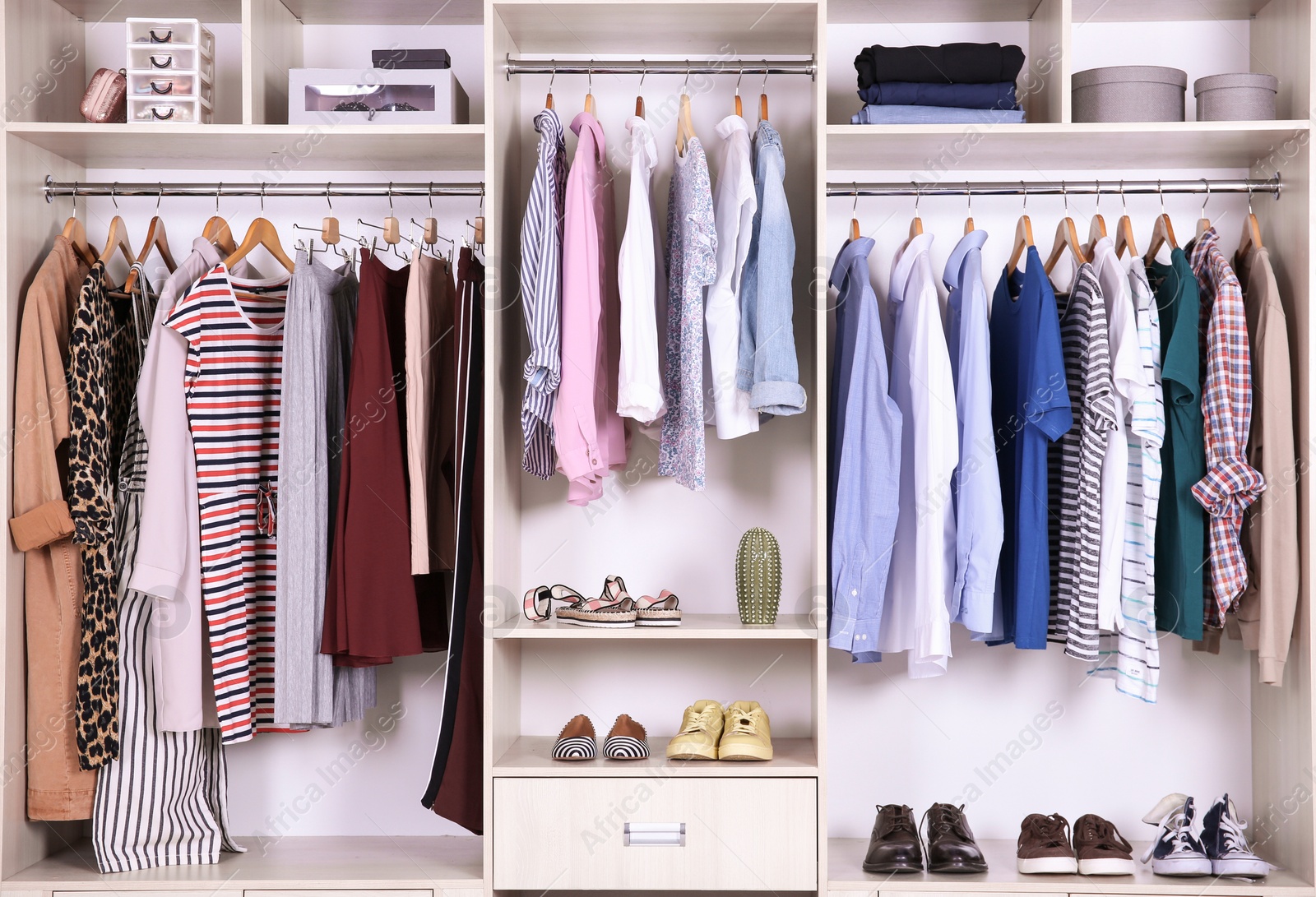 Photo of Large wardrobe with different clothes and shoes