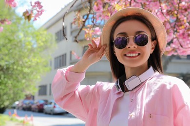 Young woman taking selfie on city street