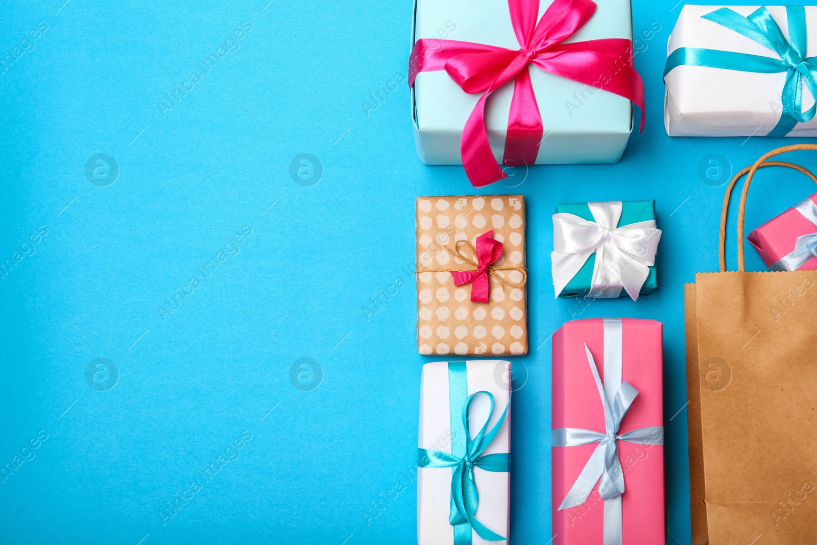 Photo of Flat lay composition with shopping bag and gifts on color background