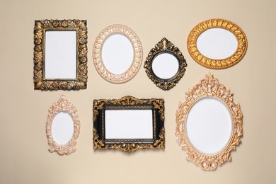 Photo of Empty vintage frames hanging on beige wall