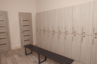 Photo of Blurred view of changing room with bench and lockers