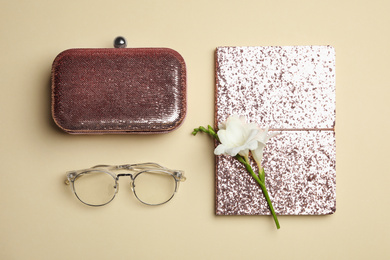 Flat lay composition with stylish woman's bag and accessories on beige background