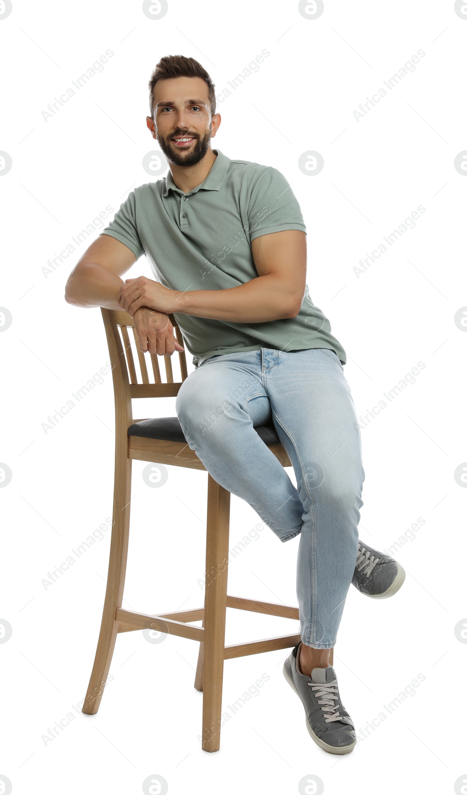 Photo of Handsome man sitting on stool against white background