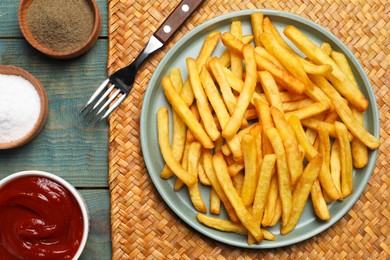 Photo of Tasty french fries served on wooden table, flat lay