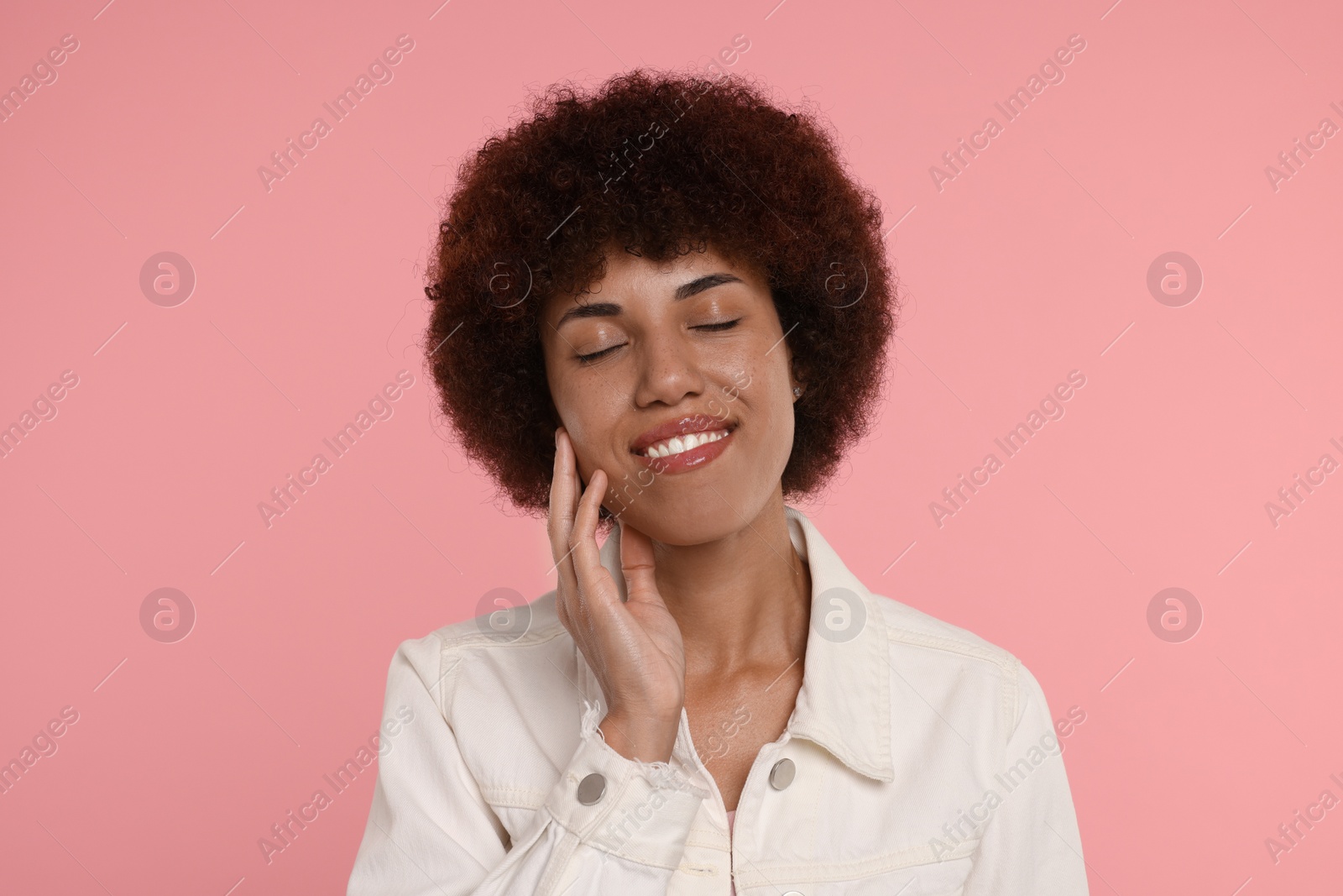 Photo of Portrait of happy young woman on pink background
