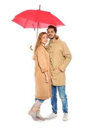 Young romantic couple with bright umbrella on white background