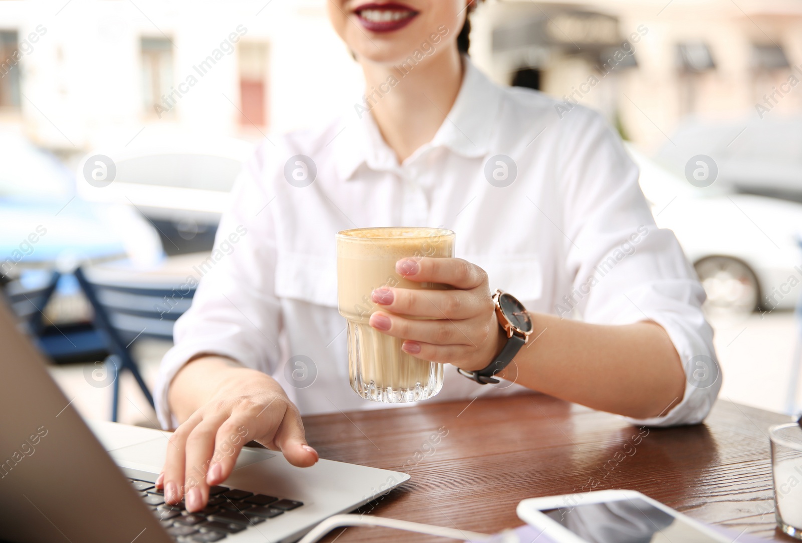 Photo of Young woman working with laptop at desk, closeup