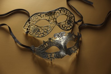 Elegant face masks on beige background. Theatrical performance