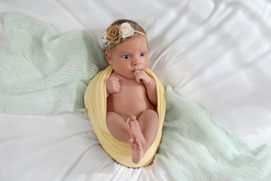 Adorable newborn baby on bed, top view