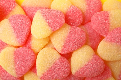 Photo of Many tasty jelly candies in shape of hearts as background, closeup