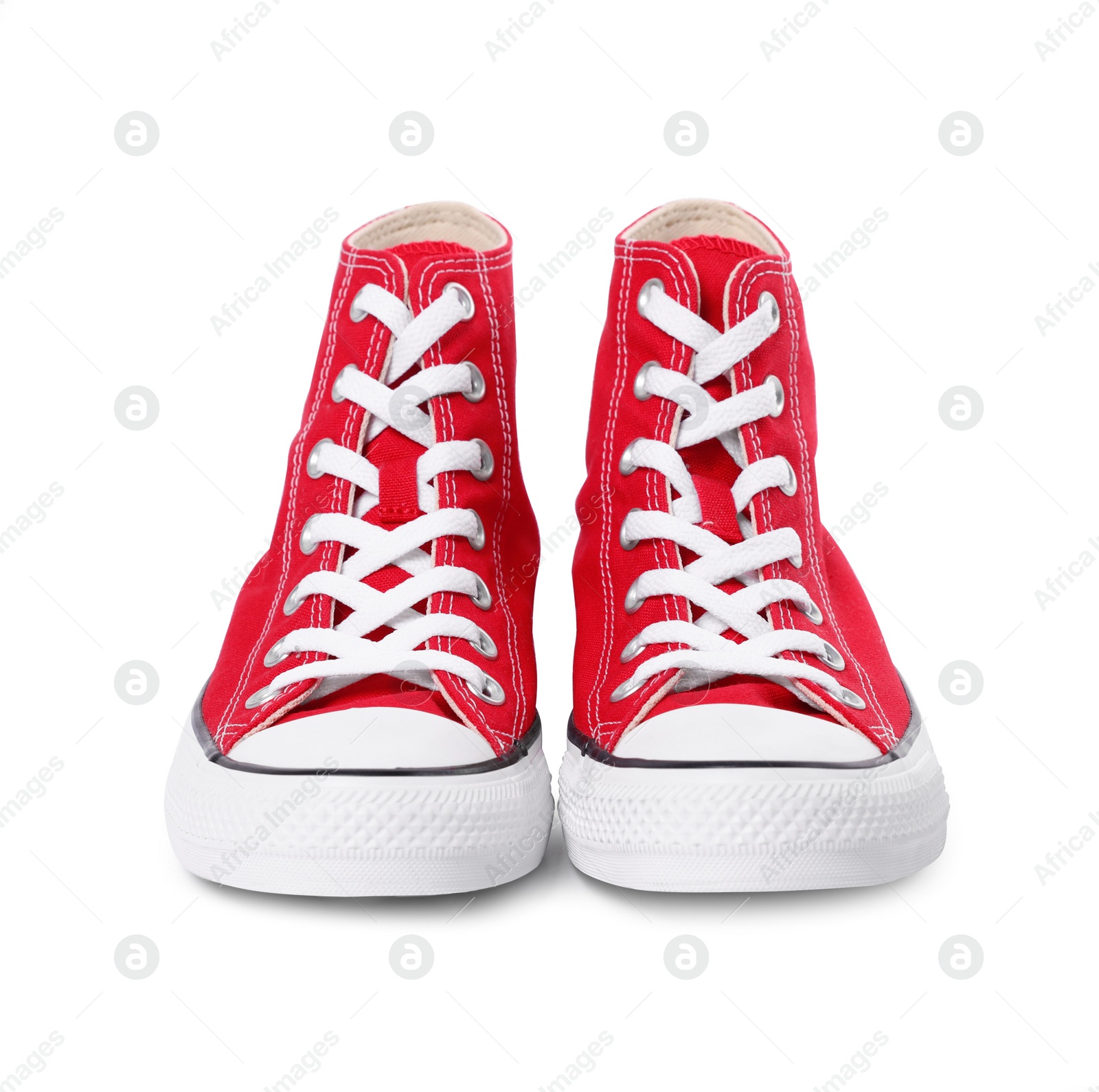 Photo of Pair of new red stylish high top plimsolls on white background