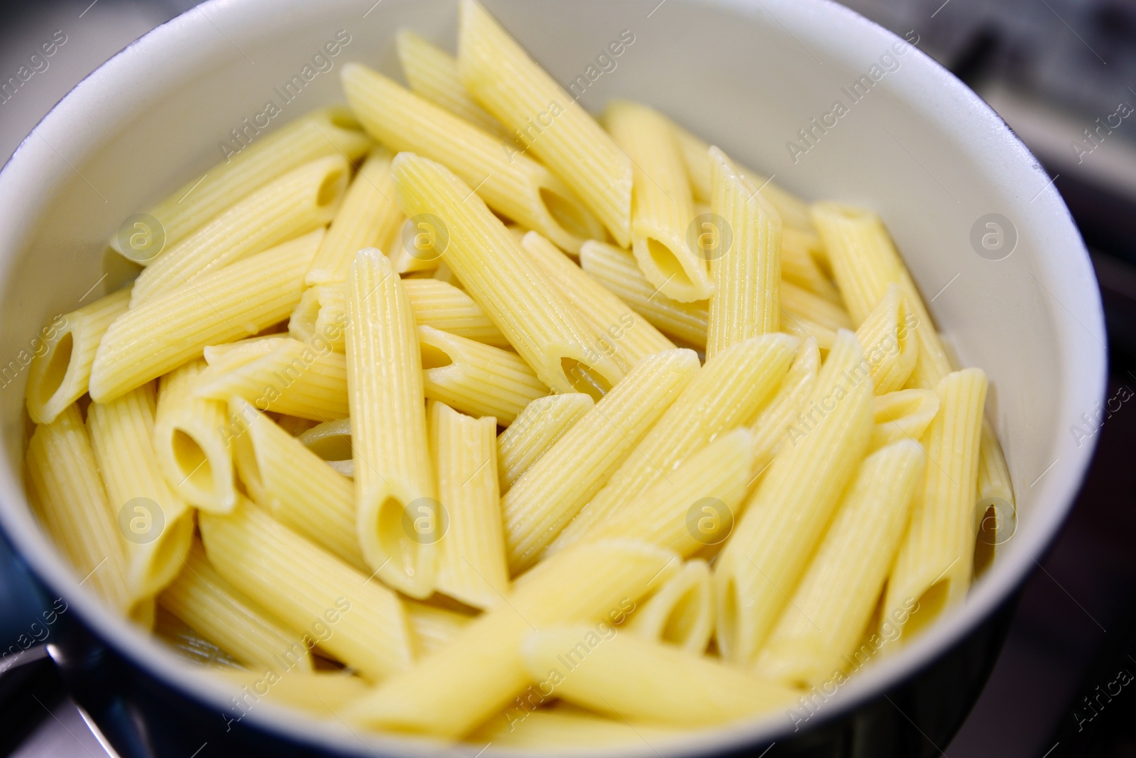 Photo of Fresh tasty pasta in pot, closeup view