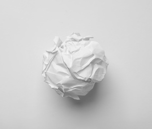 Crumpled sheet of paper on white background, top view