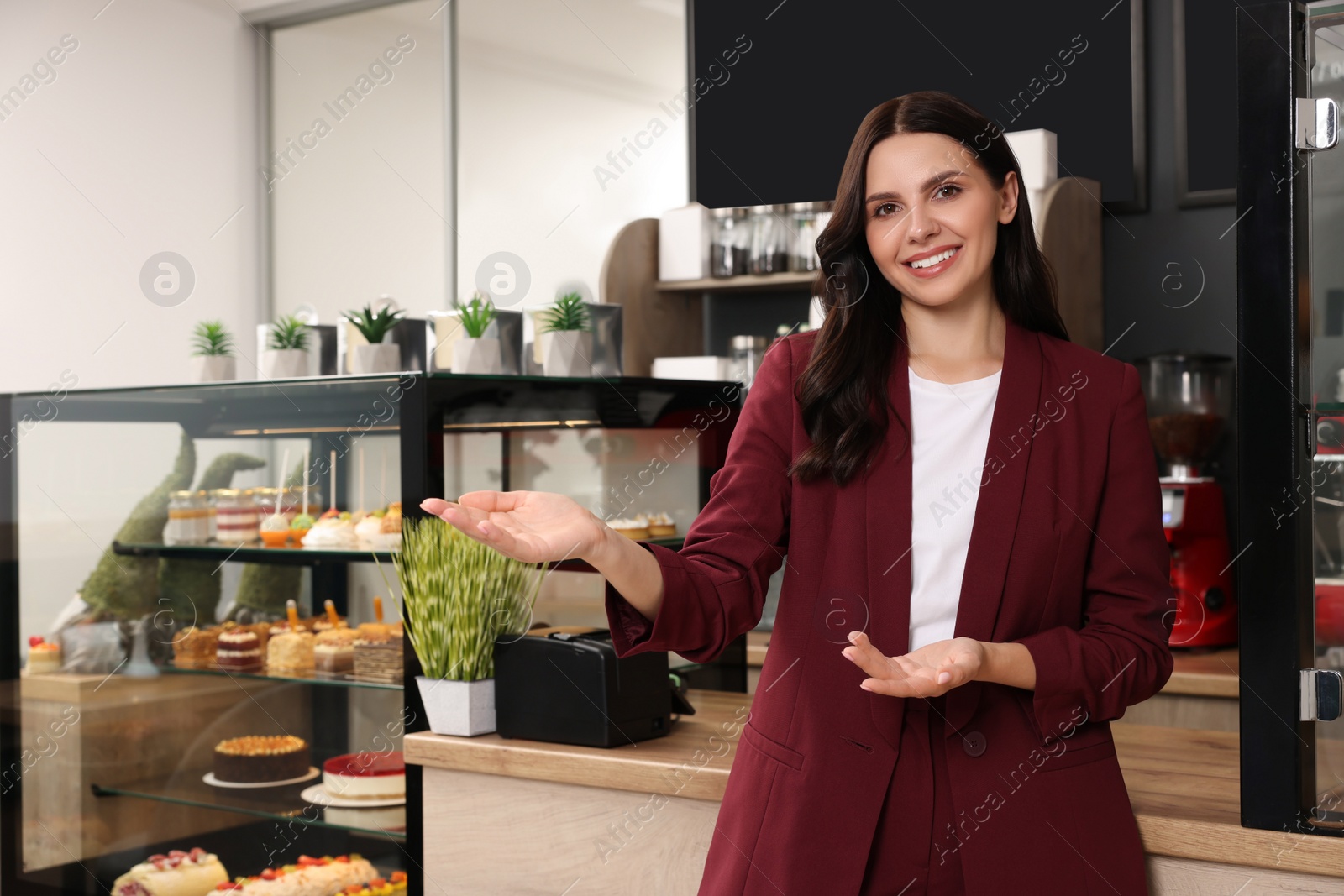 Photo of Portrait of business owner in her cafe. Space for text