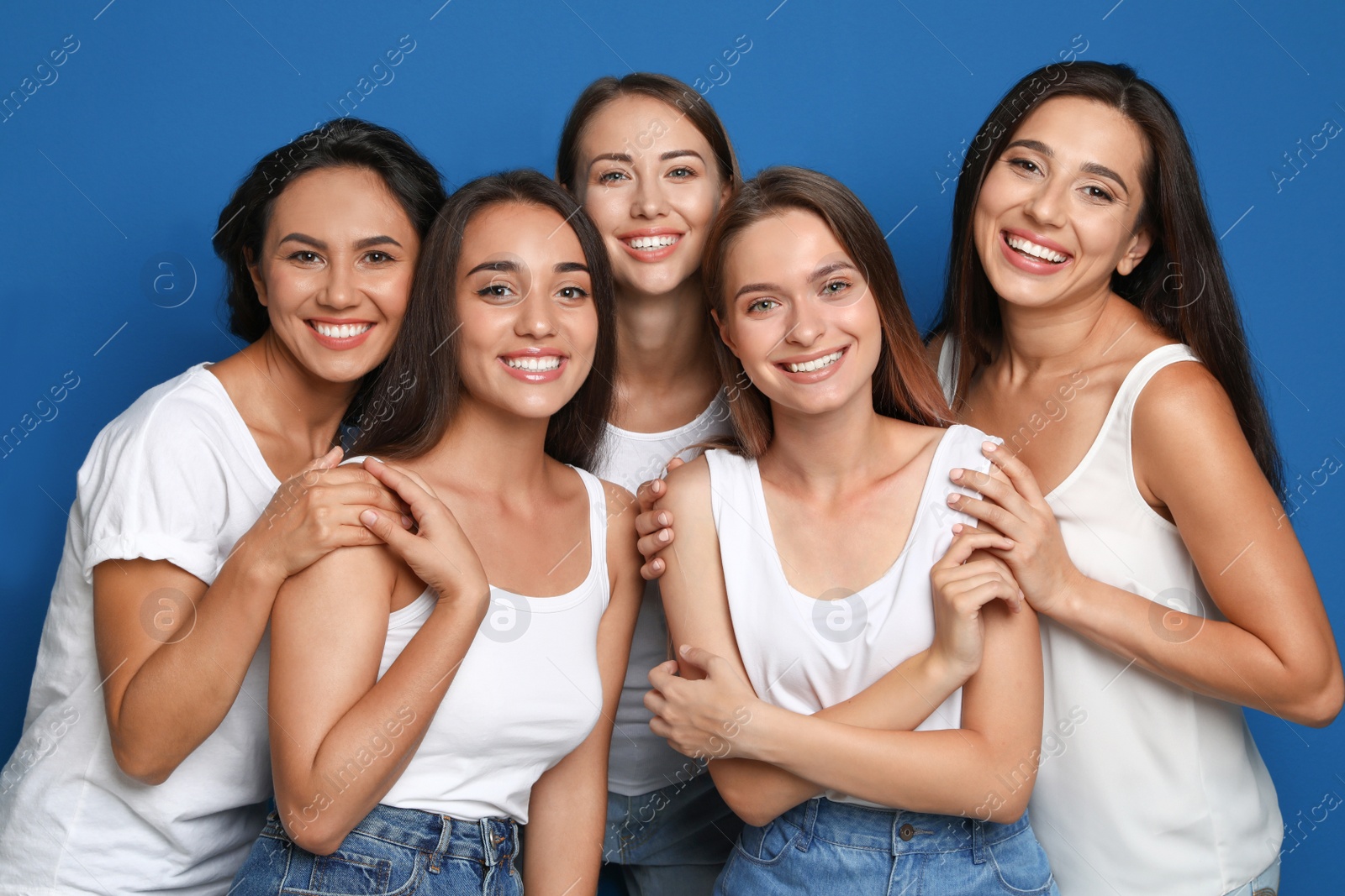 Photo of Happy women on blue background. Girl power concept