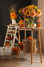 Photo of Room decorated with pumpkins and bright flowers. Autumn vibes