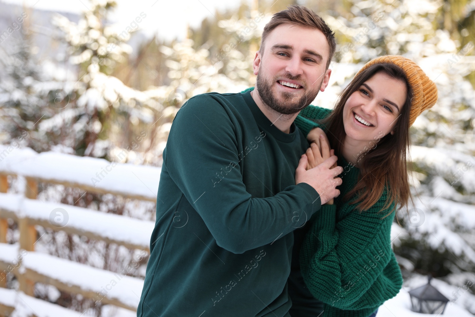 Photo of Lovely couple spending time together on snowy day. Winter vacation