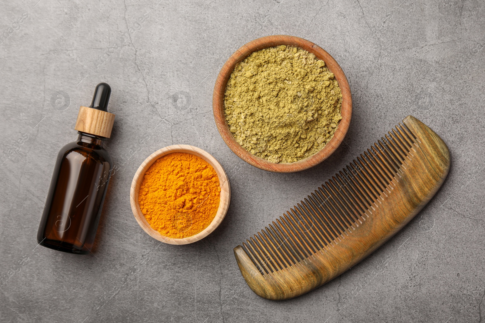 Photo of Flat lay composition with henna and turmeric powder on light grey table. Natural hair coloring