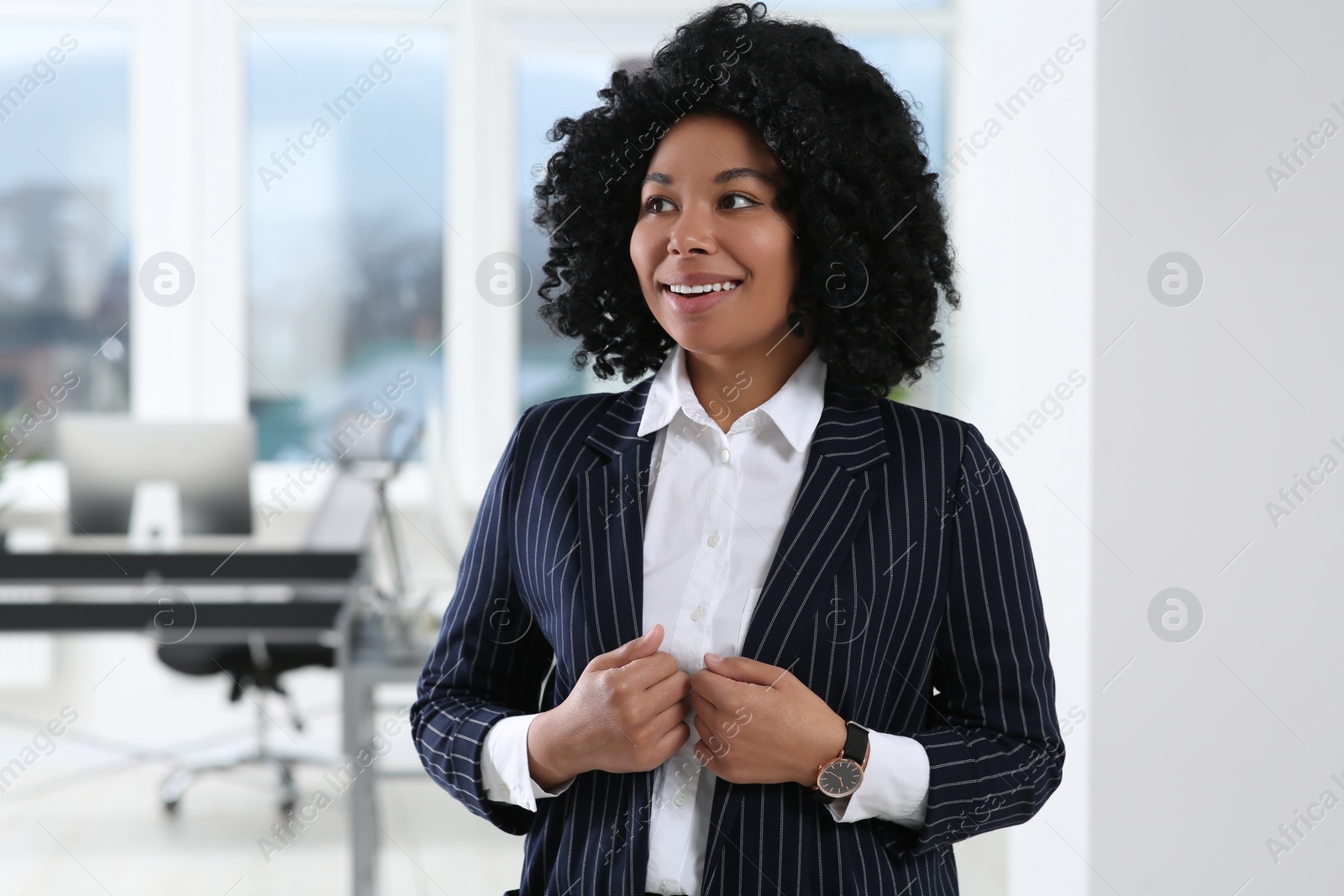 Photo of Smiling young businesswoman in her modern office