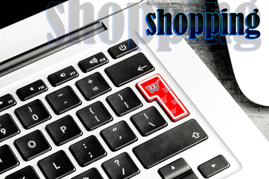 Image of Closeup view of modern laptop keyboard with cart symbol on table. Internet shopping