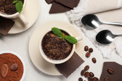 Photo of Delicious hot chocolate with fresh mint served on grey table, flat lay