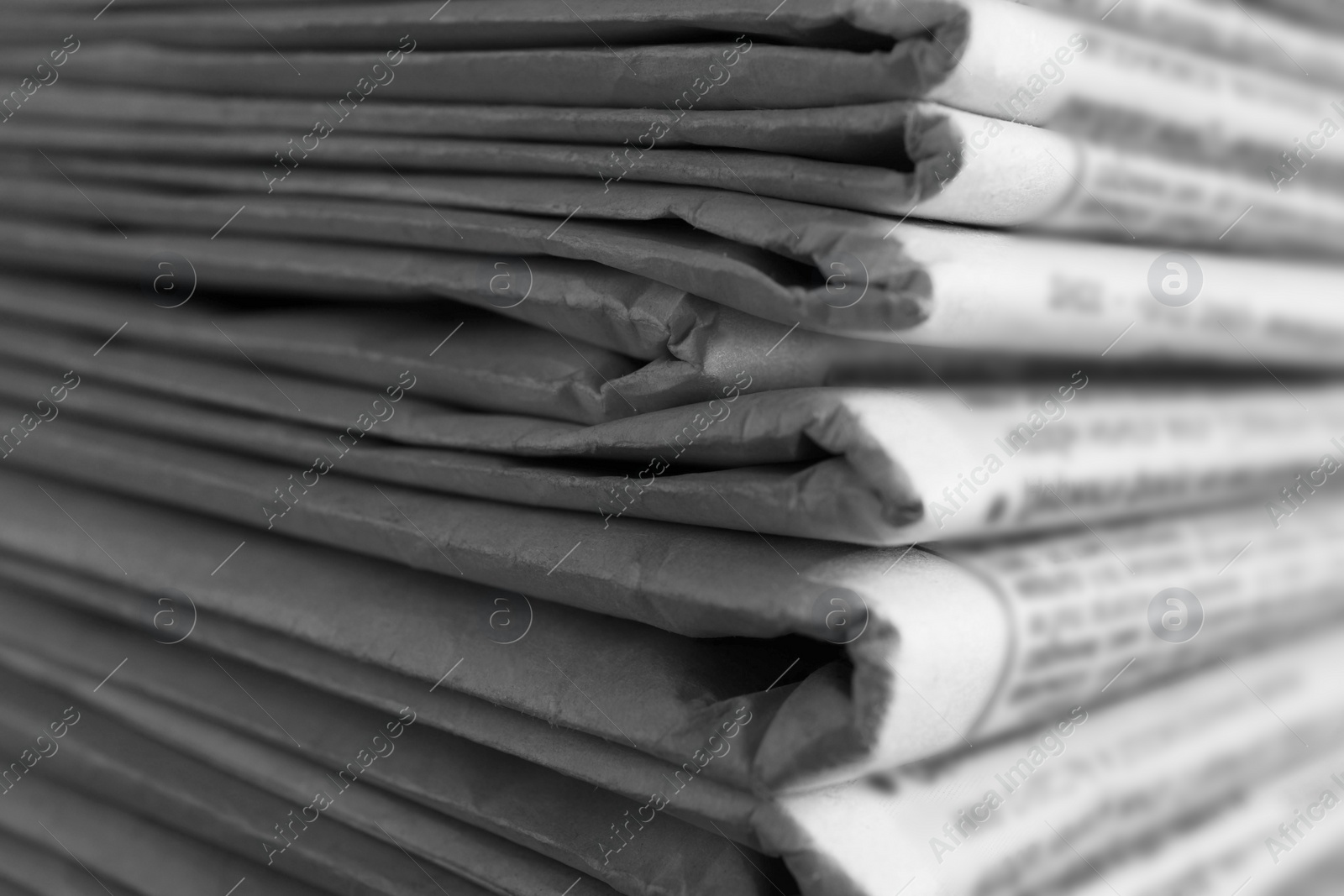 Photo of Stack of newspapers as background, closeup. Journalist's work