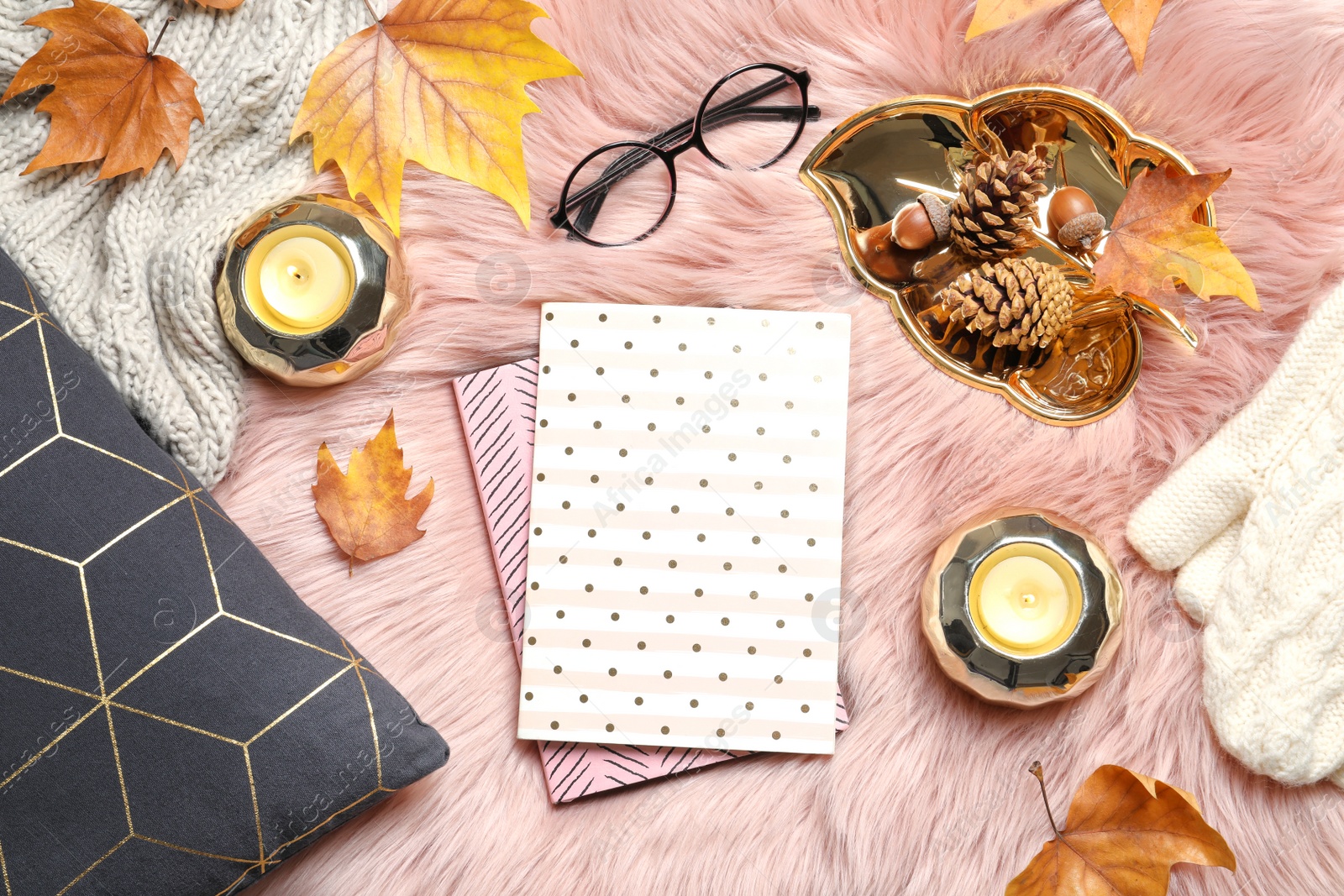 Photo of Flat lay composition with books, candles and autumn leaves on fuzzy rug