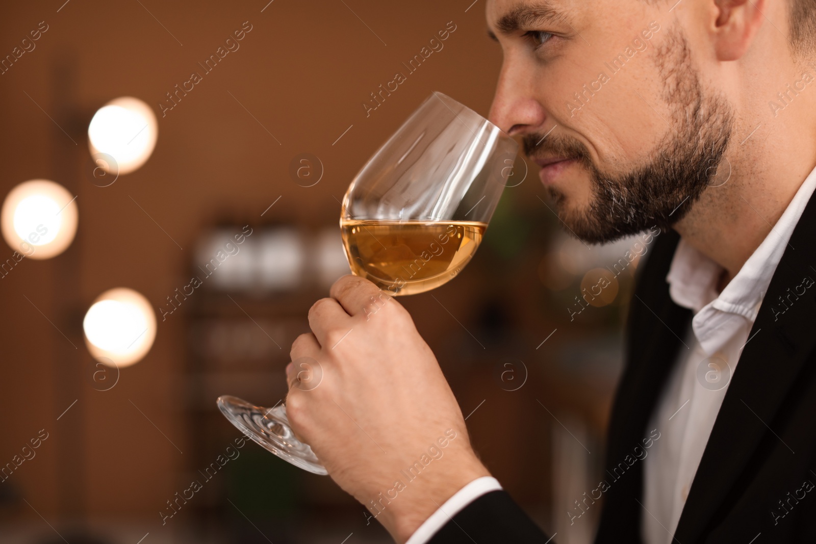 Photo of Young man with glass of wine indoors