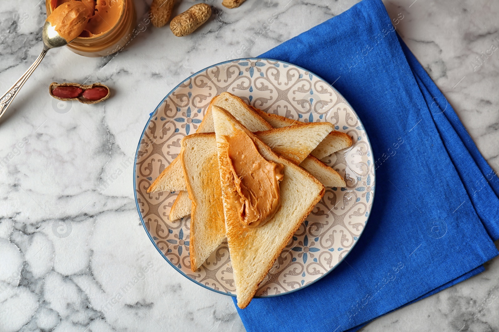 Photo of Flat lay composition with peanut butter and toasts on marble background