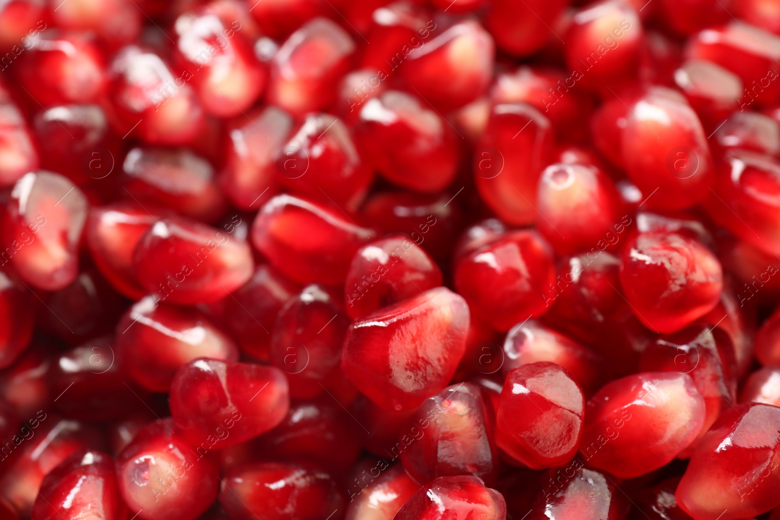 Photo of Ripe juicy pomegranate grains as background, closeup