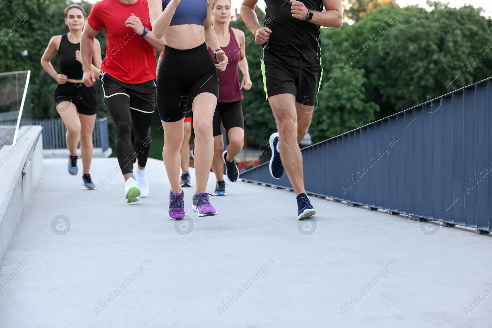 Photo of Group of people running outdoors, closeup view