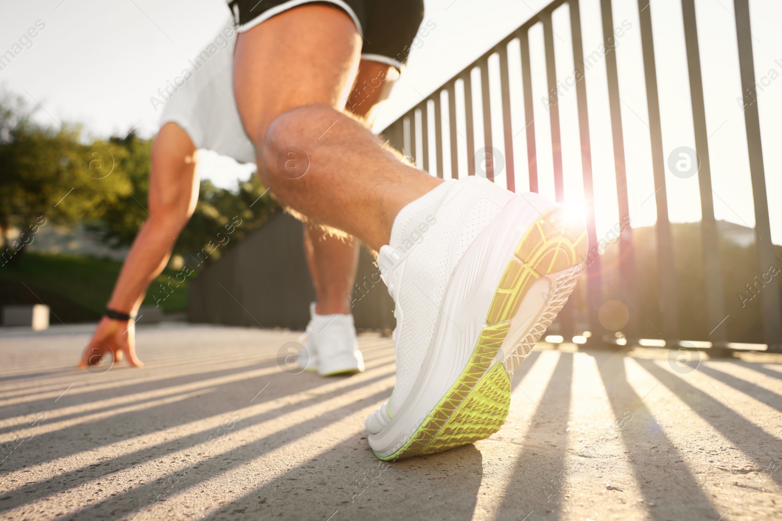 Photo of Runner on starting position outdoors on sunny day, low angle view