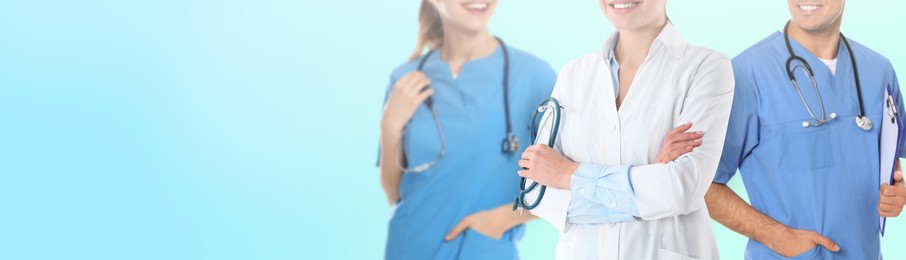 Image of Doctors and nurse on light blue background, closeup. Banner design with space for text