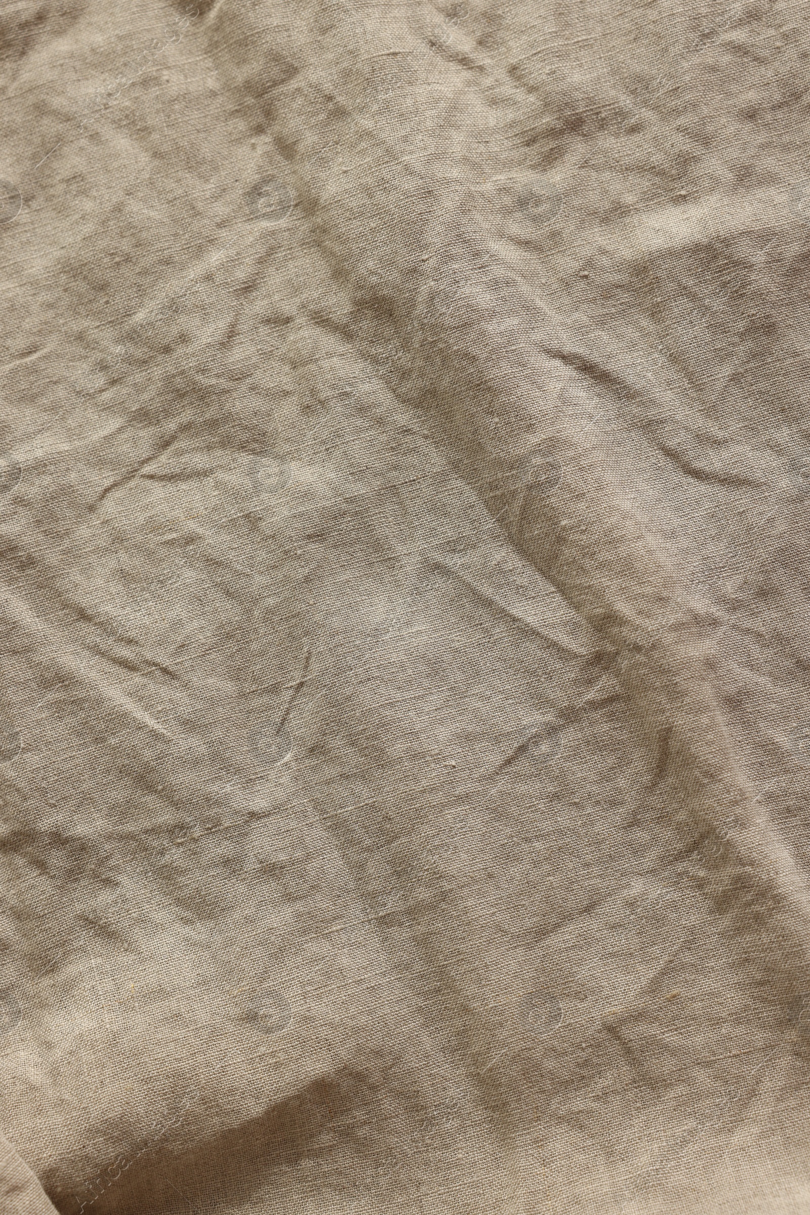 Photo of Beautiful beige fabric as background, top view