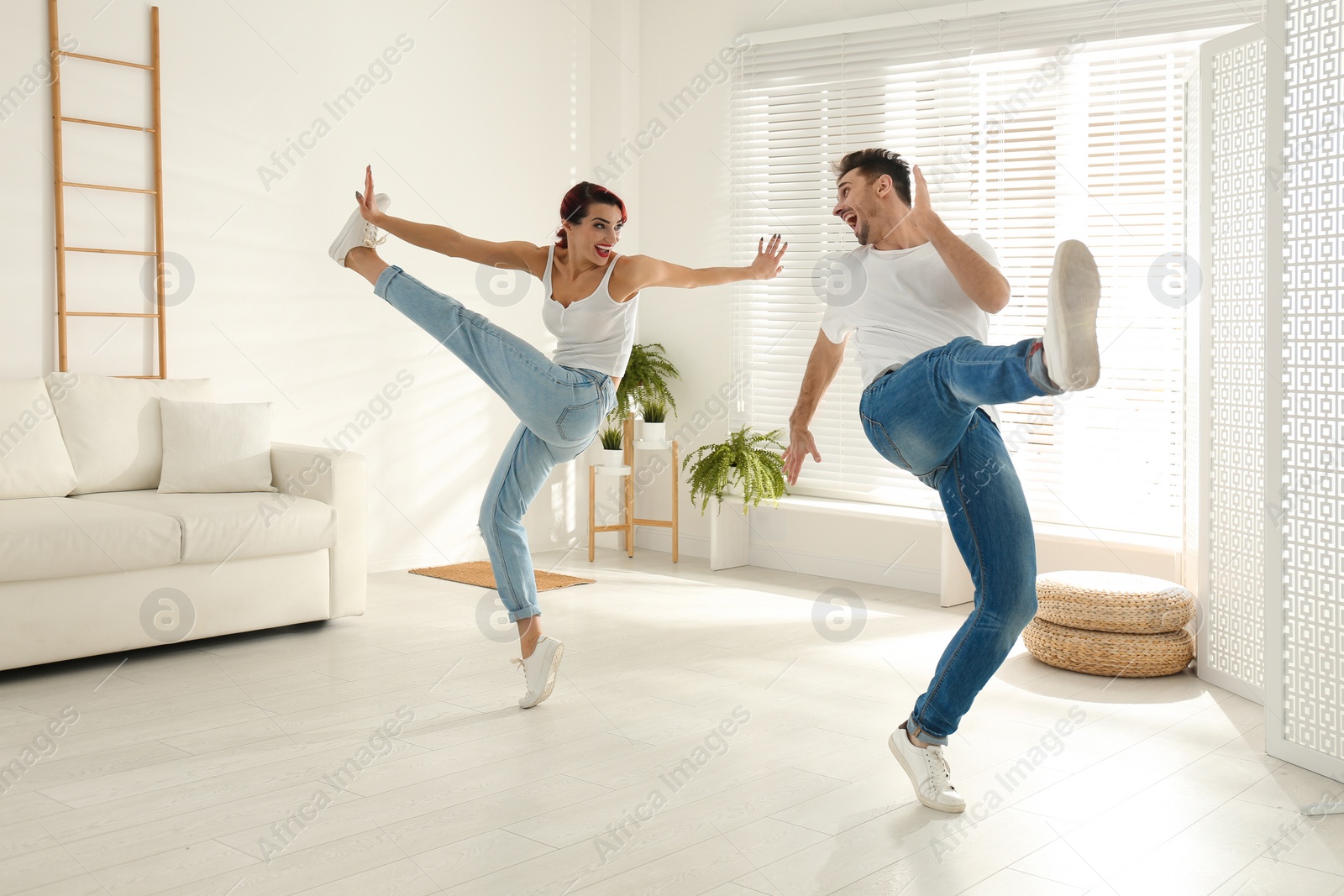Photo of Beautiful young couple dancing in living room
