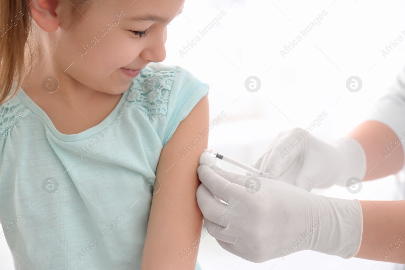 Photo of Doctor vaccinating little girl in hospital