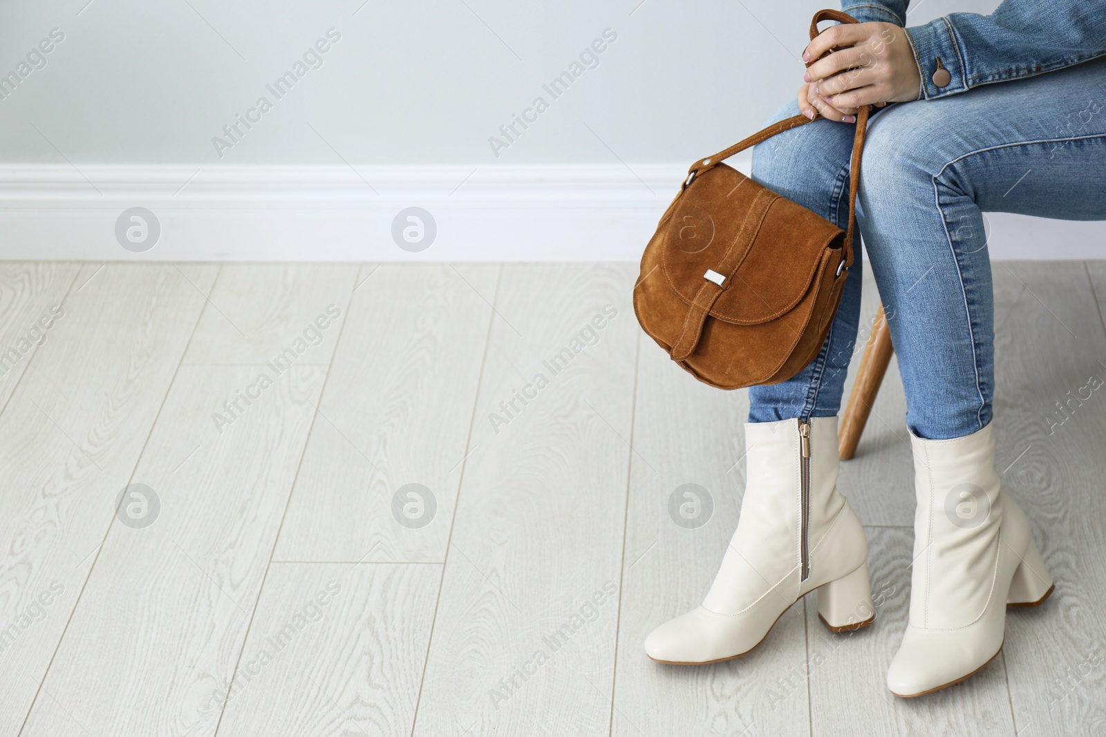 Photo of Woman in stylish leather shoes with bag indoors, closeup. Space for text