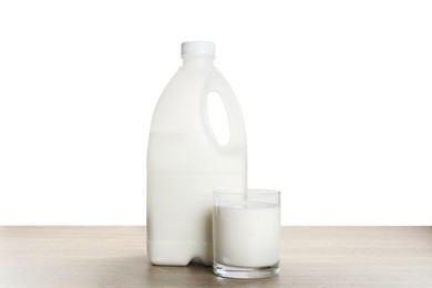 Photo of Gallon bottle and glass of milk on wooden table