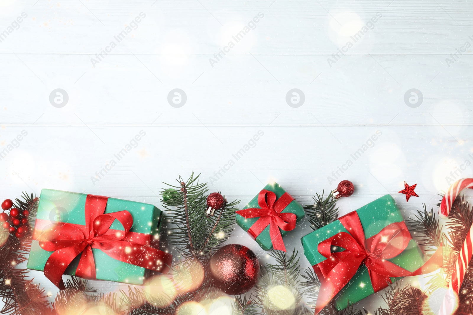 Image of Flat lay composition with gift boxes and Christmas decorations on white wooden table, space for text