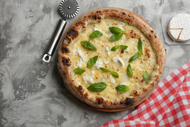 Delicious cheese pizza with basil on grey table, flat lay