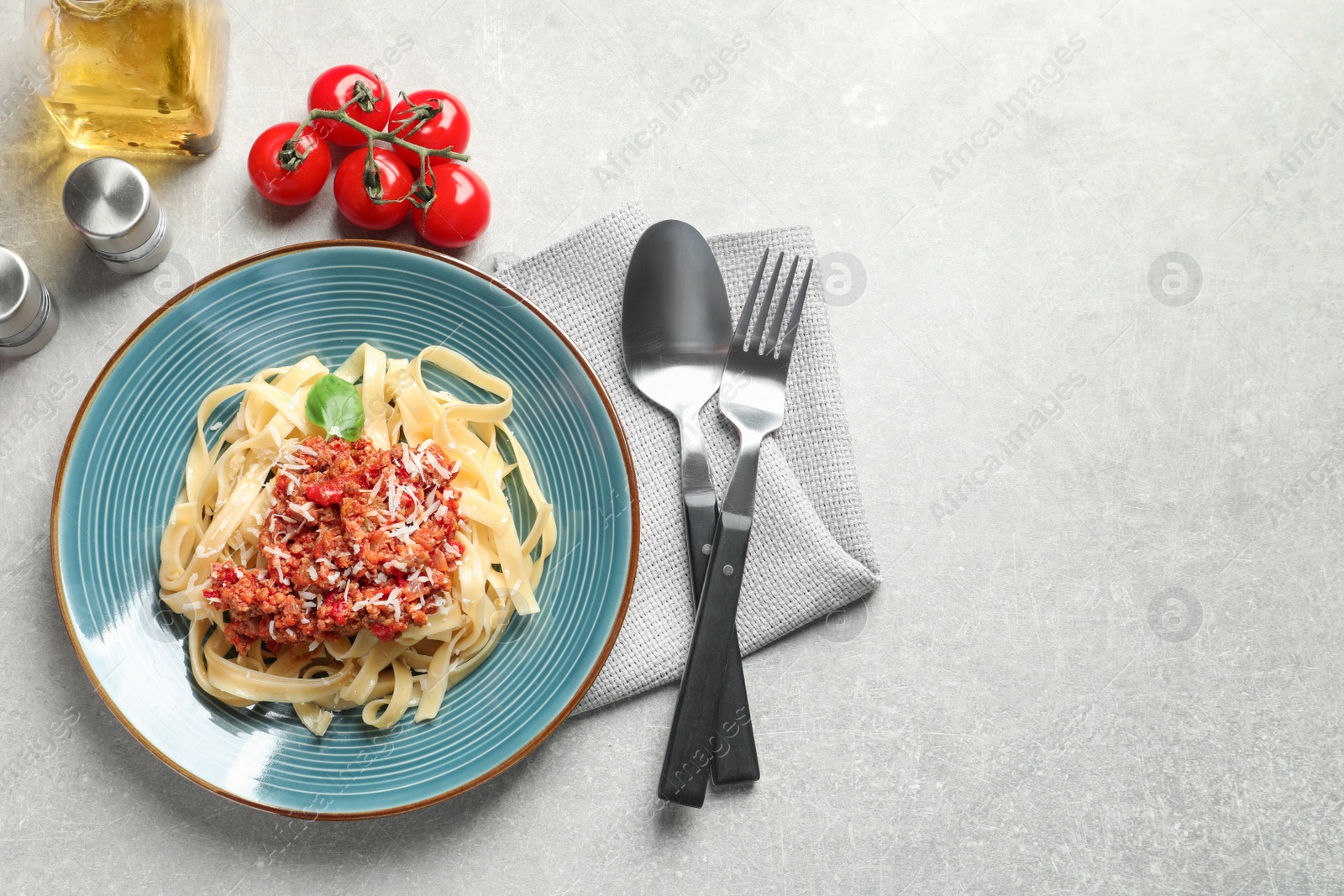 Photo of Plate with delicious pasta bolognese on light background, top view