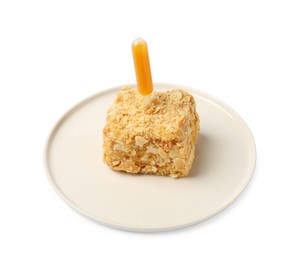 Piece of Napoleon cake with jam pipette on white background