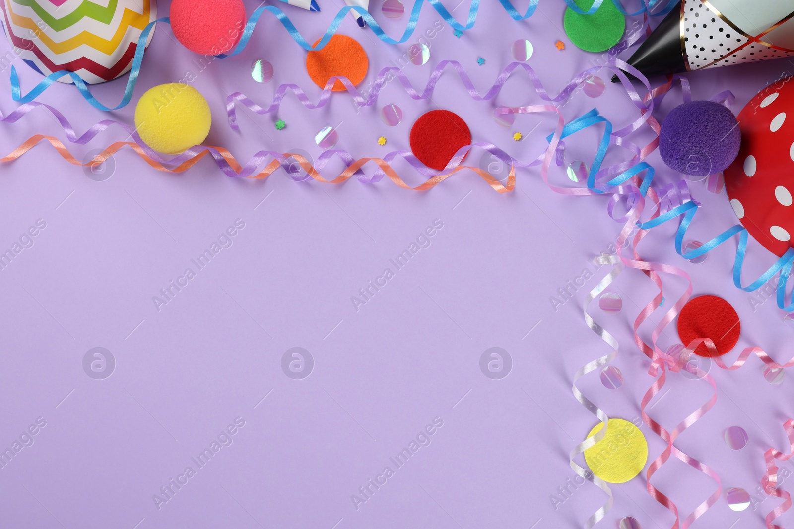 Photo of Flat lay composition with colorful serpentine streamers and confetti on violet background, space for text