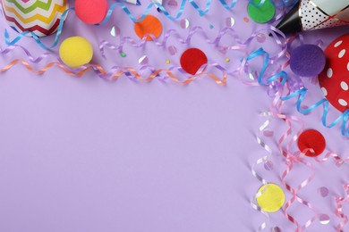 Flat lay composition with colorful serpentine streamers and confetti on violet background, space for text