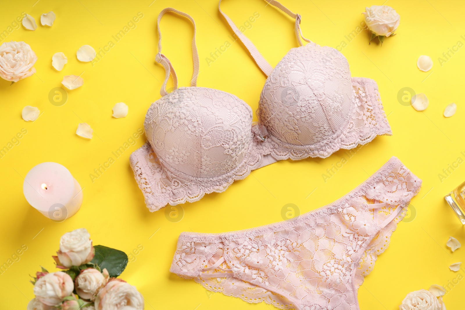 Photo of Flat lay composition with sexy women's underwear on yellow background