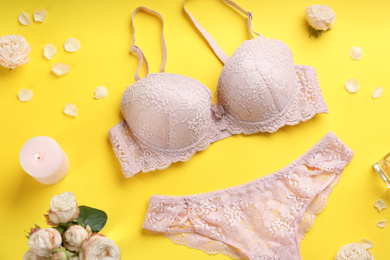 Flat lay composition with sexy women's underwear on yellow background