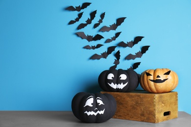 Photo of Set of Halloween decorations on table against color background. Space for text