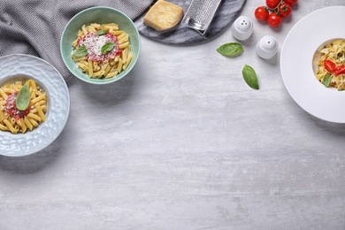 Photo of Delicious pasta with tomato sauce served on white table, flat lay. Space for text