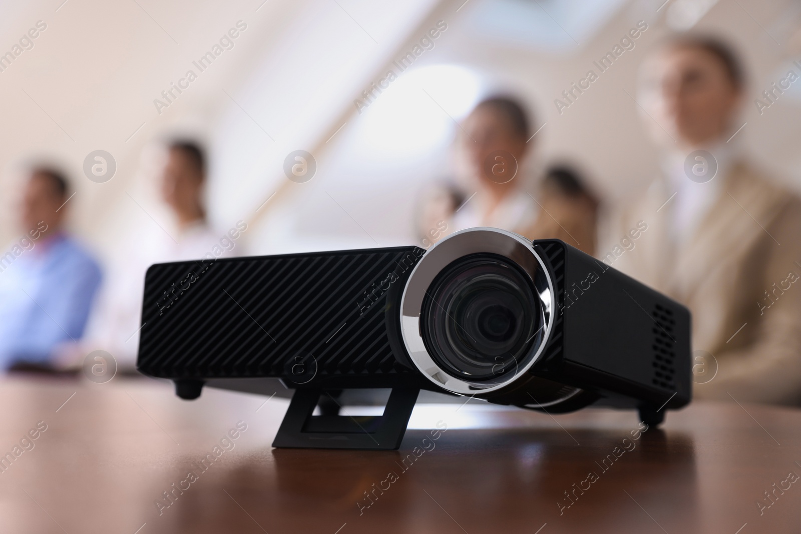 Photo of Modern video projector on table during conference