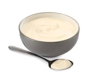 Photo of Ceramic bowl and spoon with mayonnaise on white background